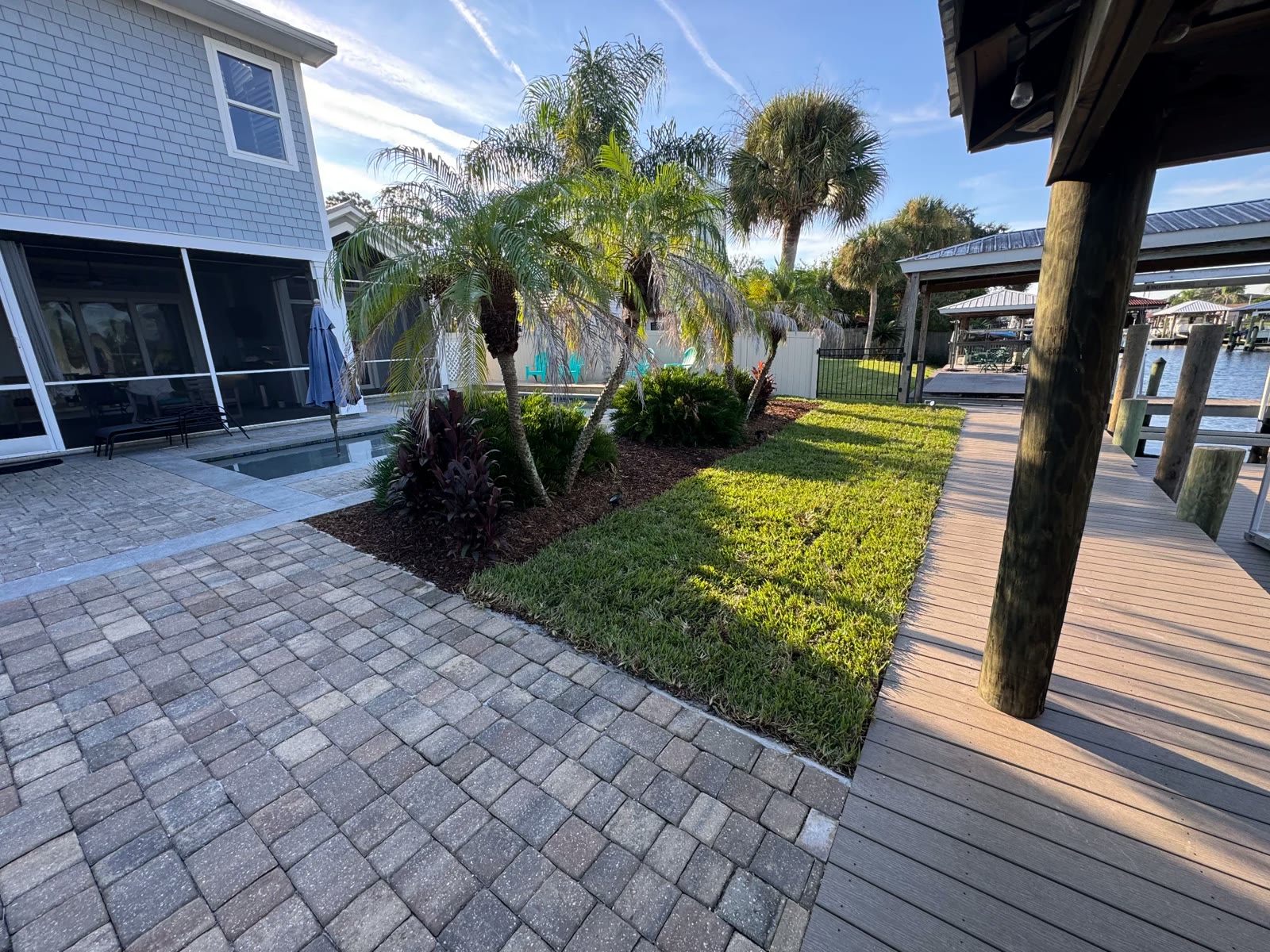 Paver patio, sod, and composite dock walkway
