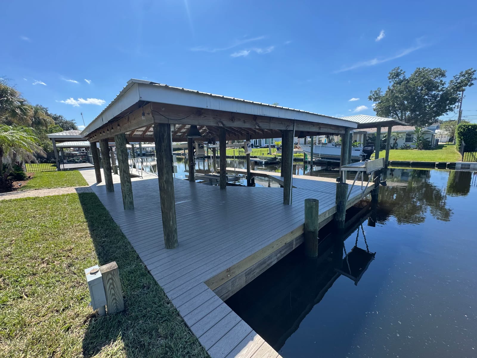 Covered boathouse and dock built by Topping Brothers