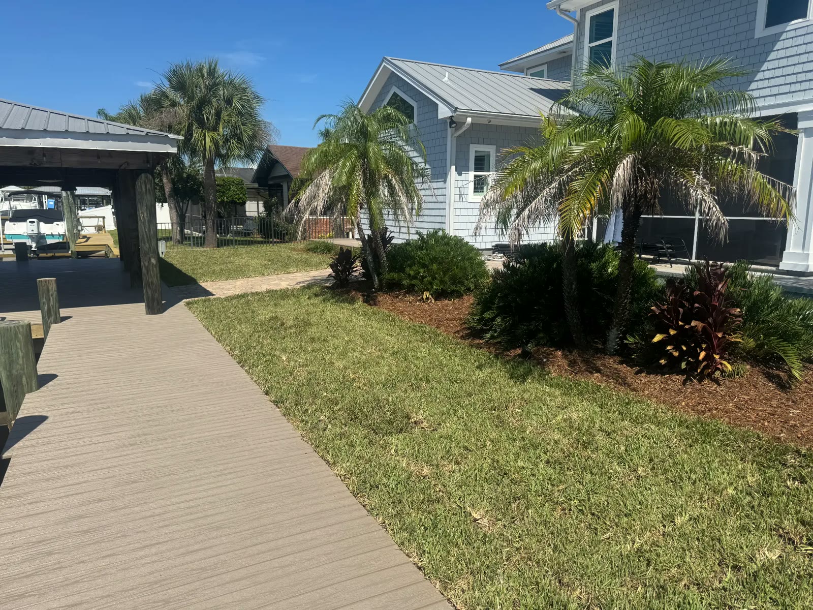 Composite walkway and lawn by the waterfront home